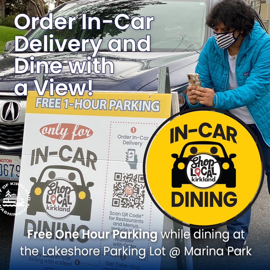 Woman holding phone at In Car Dining sign using QR code feature