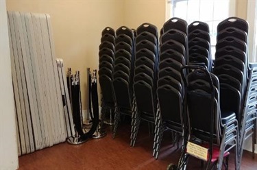 View of tables an chairs stacked in Hall