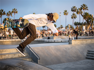 Photo of a teen boy at an outdoor skate park