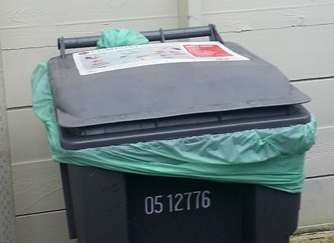 multifamily compost cart with compostable liner inside enclosure