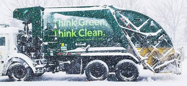 Waste Management truck from the side on a snowy day