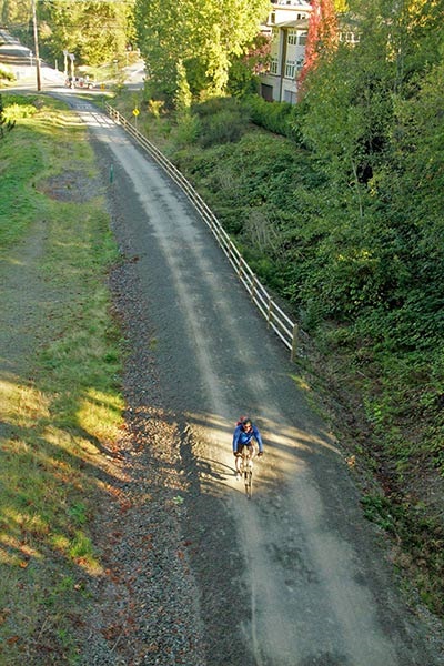 person riding bike on Cross Kirkland Corridor trail from above, taken from NE 85th Street overpass