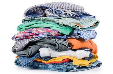 stack of colorful folded clothing and textiles on white background