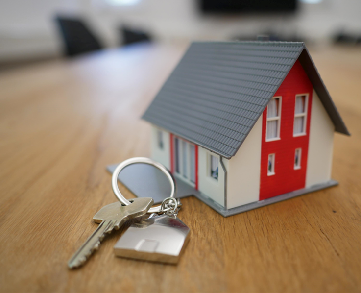 miniature red and white home with a set of keys