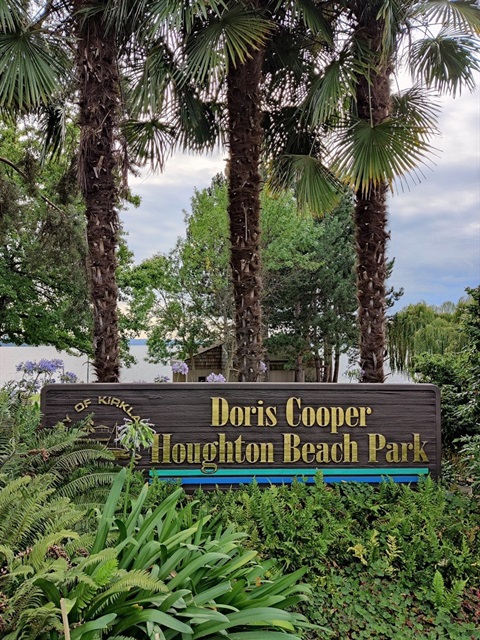 Park sign for Houghton Beach Park with trees and green foliage