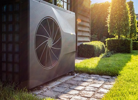 Image of a heat pump outside a home.