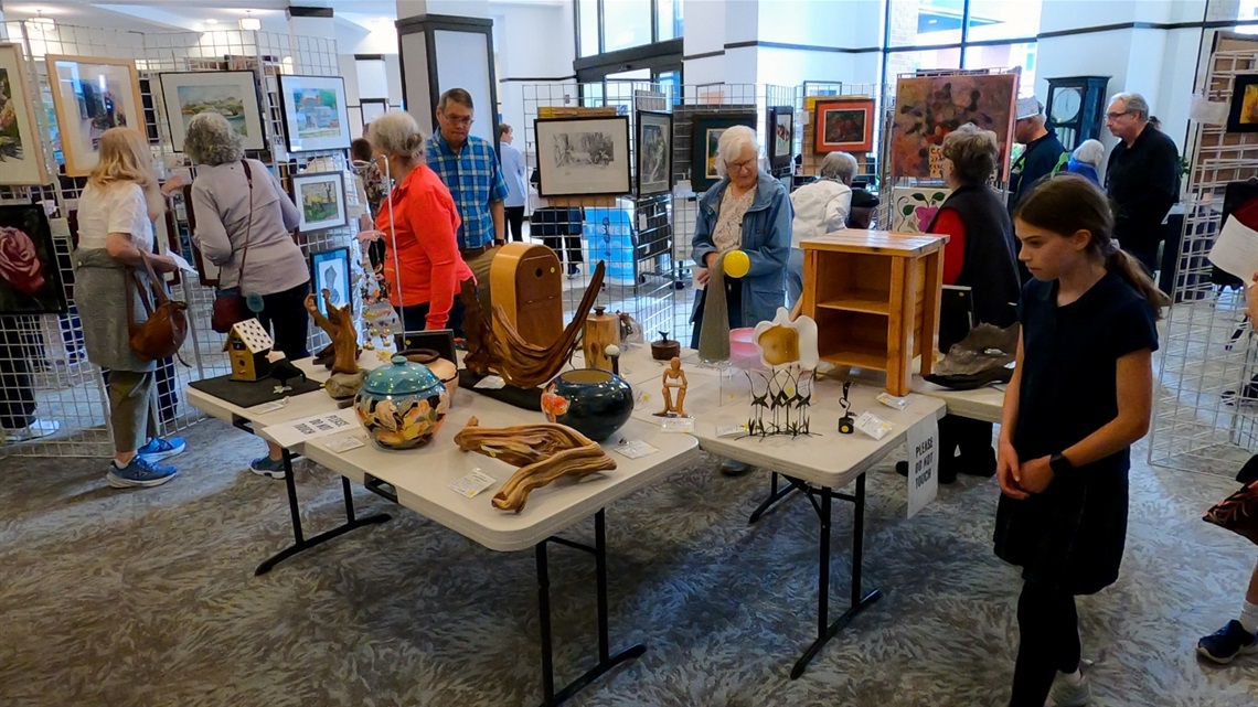 Image shows attendees perusing the art displays at the 2026 Senior Art Show.