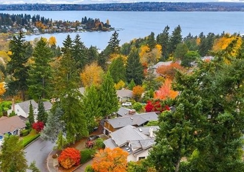 Aerial shot of Kirkland with fall color, rooftops and view of Lake Washington