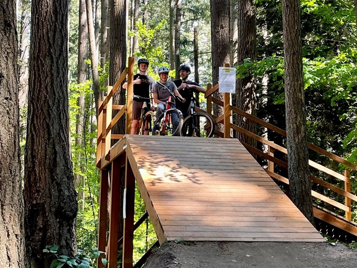 Three bikers at the top of the bike ramp at South Norway Hill Park