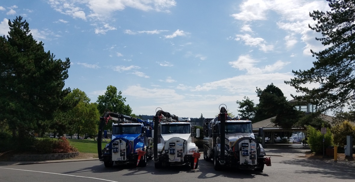 3 vactor tucks lined up in front of Al Lock pavilion at Marina Park.