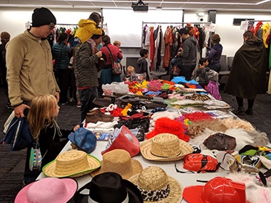 families browsing for halloween costume at our costume swap reuse event