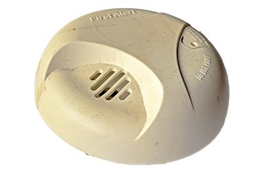 old smoke detector on white background