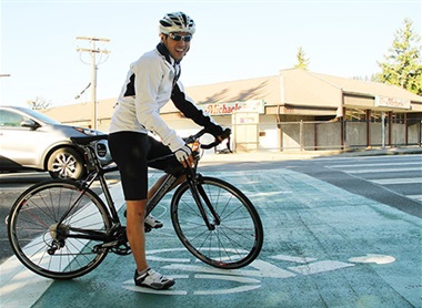 cyclist using bike box at 100th Ave intersection in Juanita near Juanita Village and Michael's