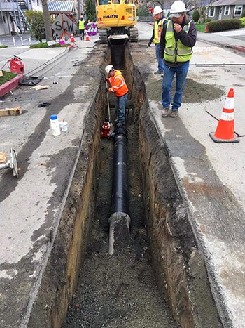installing pipe in a trench in the road