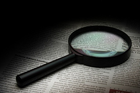 Magnifying glass on a newspaper